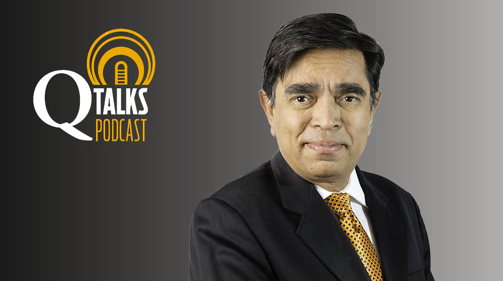 Arup Varma against a gray background with the Q Talks Podcast logo.